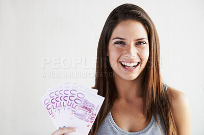 Buy stock photo Portrait of a young woman holding a fanned-out wad of Euros in her hand