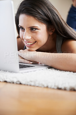 Buy stock photo Woman, lying and laptop on floor in home for work, research or creative writing for job. Female author, alone and thinking with smile while reading on screen for review, feedback or message by web