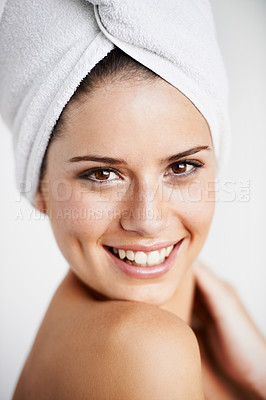 Buy stock photo Happy, skincare and woman with towel in a studio for health, wellness and natural face routine. Smile, beauty and portrait of young female model with facial dermatology treatment by gray background.