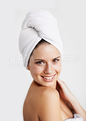 Buy stock photo Happy, beauty and woman with towel in a studio for health, wellness and natural face routine. Smile, skincare and portrait of young female model with facial dermatology treatment by gray background.