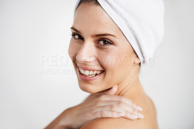 Buy stock photo Smile, cosmetic and woman with towel in a studio for health, wellness and natural face routine. Happy, beauty and portrait of young female model with facial dermatology treatment by gray background.