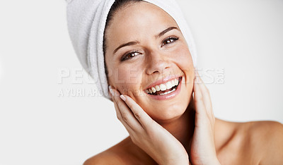 Buy stock photo Smile, portrait and woman with towel for skincare in a studio for health, wellness and natural face routine. Happy, beauty and young female model with facial dermatology treatment by gray background.