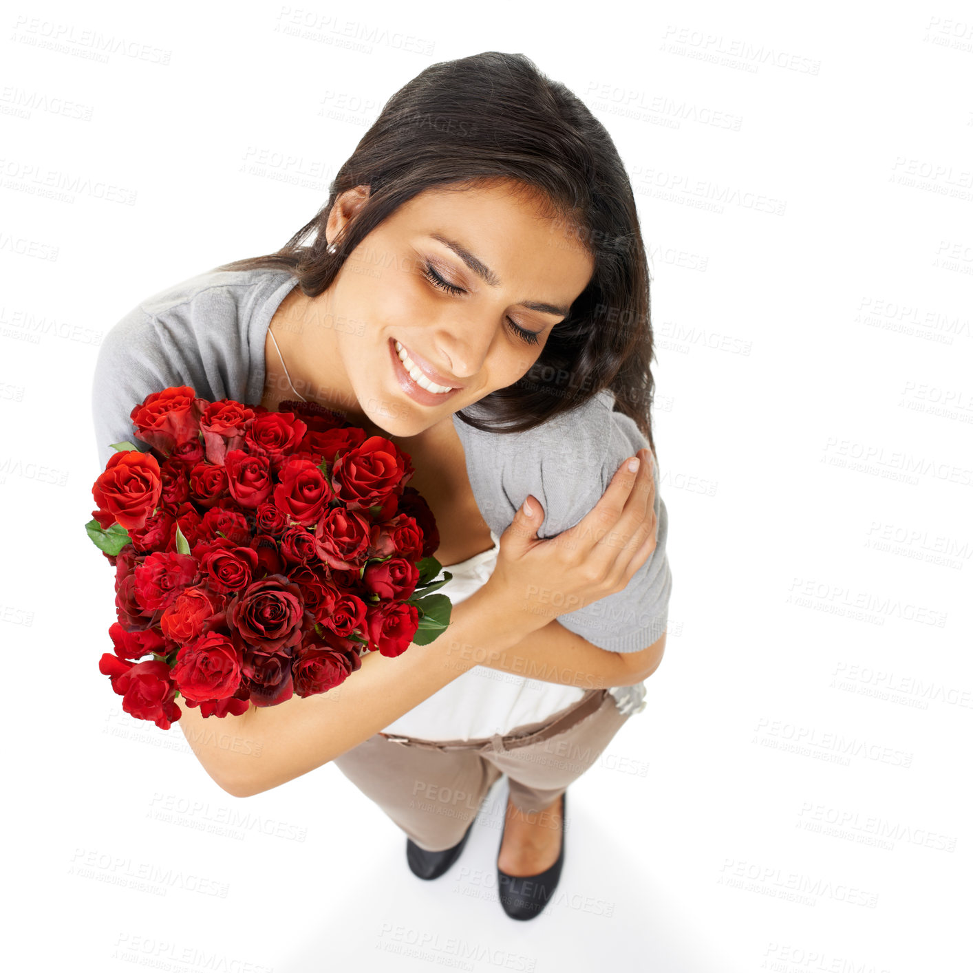 Buy stock photo Above, hug and woman with rose in studio for love, romance and valentines day against a white background space. Happy, smile and bouquet for indian girl embrace floral, gesture and romantic isolated