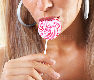 Buy stock photo Closeup shot of a woman sucking a lollipop