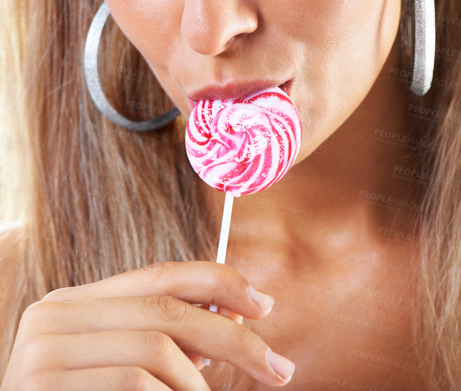 Buy stock photo Closeup shot of a woman sucking a lollipop