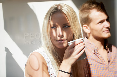 Buy stock photo Love, city and couple with coffee relax for date, relationship and bonding outdoors on weekend. Dating, thinking and man and woman in sunlight with drink for holiday, vacation and adventure in town