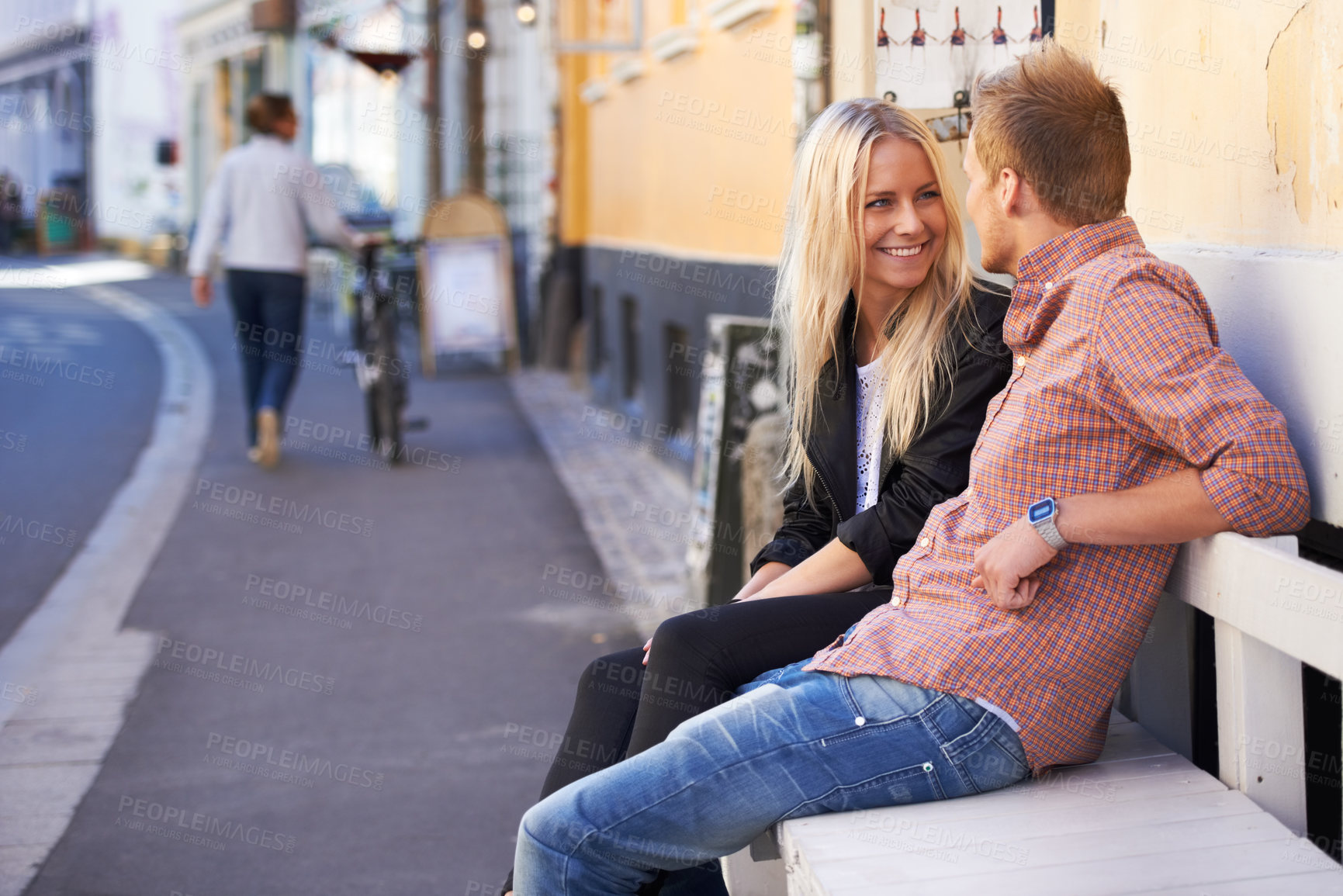 Buy stock photo Couple, love or happy on bench in city, weekend relax or communication in healthy relationship. English man, woman or smile for conversation in marriage, care or romance together outdoor in cambridge