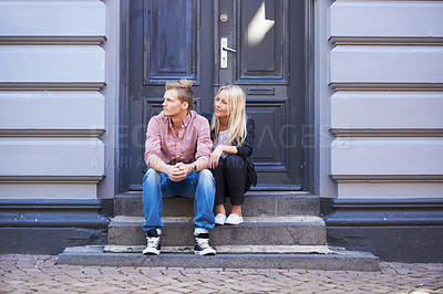 Buy stock photo Love, city and couple on building steps for date, cute relationship and bonding outdoors on weekend. Dating, romance and man and woman sitting for flirting, connection and adventure in urban town