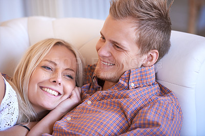 Buy stock photo Happy, love and couple relax on a sofa with hug, care or bonding in their home together. Support, security and people embrace in living room resting, conversation and enjoying the weekend in a house