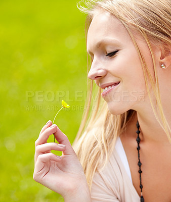 Buy stock photo Woman, smile and smelling a flower in grass, garden or outdoor in field with growth in spring. Nature, happiness and person relax with daisy, blossom and peace in park, backyard or green meadow