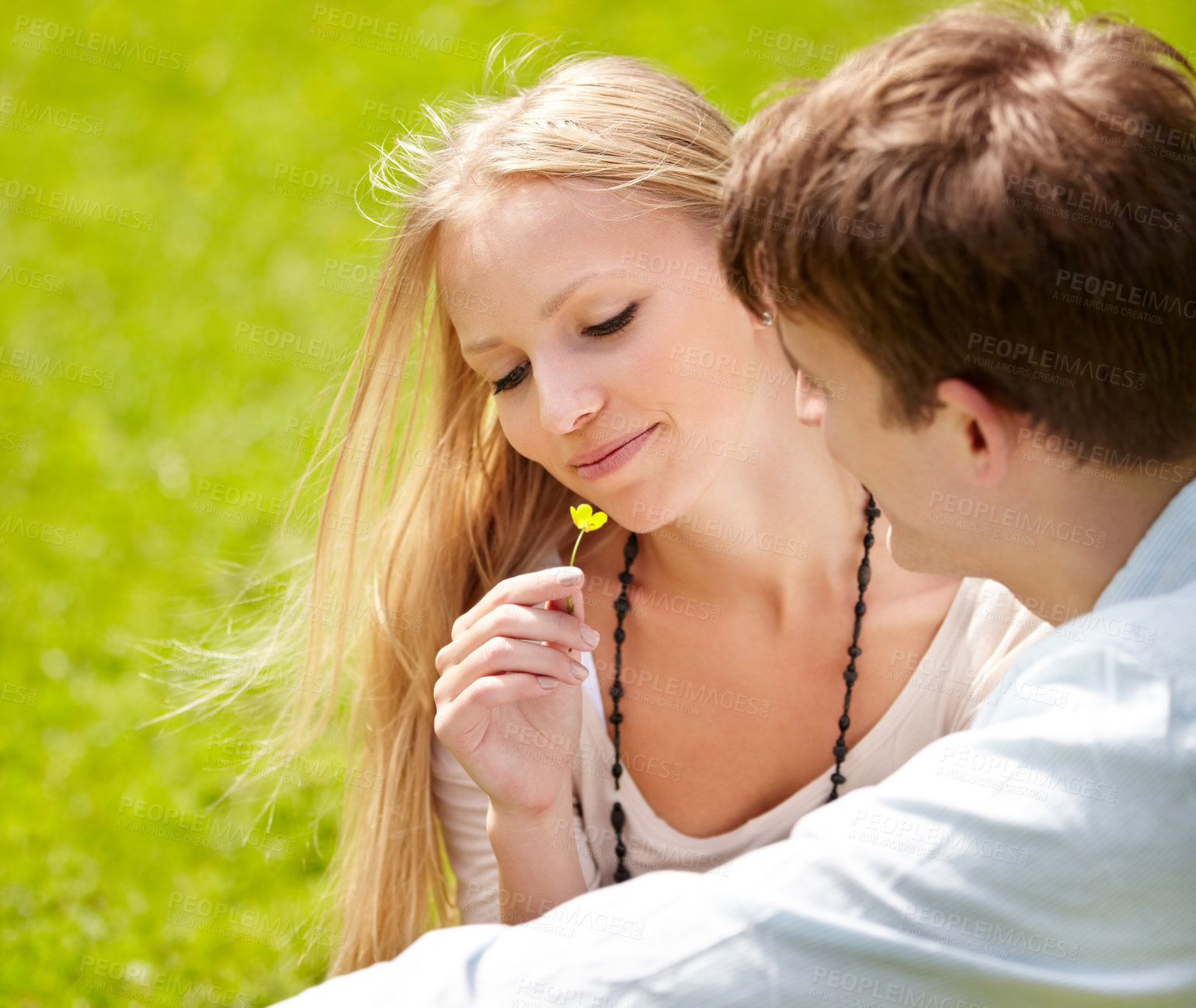 Buy stock photo Young couple sitting together in the park