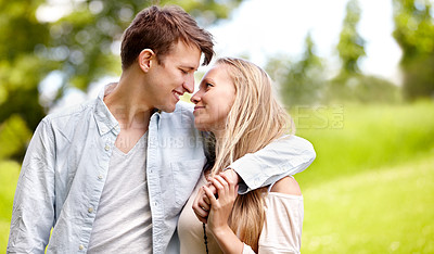 Buy stock photo Young couple standing together in the park