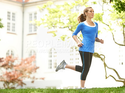 Buy stock photo Attractive young woman out for a run