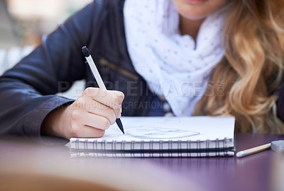 Buy stock photo A young woman drawing in her notepad
