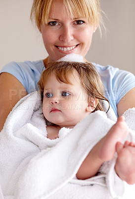 Buy stock photo Portrait, mother and baby with happiness in a towel for bath with bond and love in a closeup at house. Child, care and mom with towel for hug for comfort and affection with smile in family home.