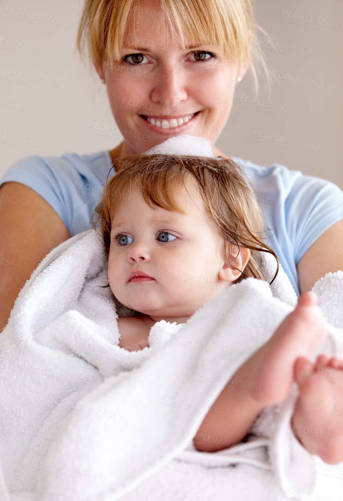 Buy stock photo Portrait, mother and baby with happiness in a towel for bath with bond and love in a closeup at house. Child, care and mom with towel for hug for comfort and affection with smile in family home.