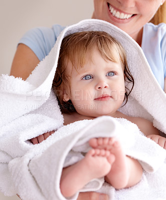Buy stock photo Mom, hug and baby with bath for care or clean kid in a closeup at home with love for family life. Infant, towel and mother to hold with caring in arm for bond or cleaning or wellness of child.