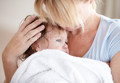 Buy stock photo Hug, love and a mother with a child after a bath for heat, care and cuddling. Family, comfort and a mom holding a baby after a wash, hugging and embracing for closeness, bonding and affection