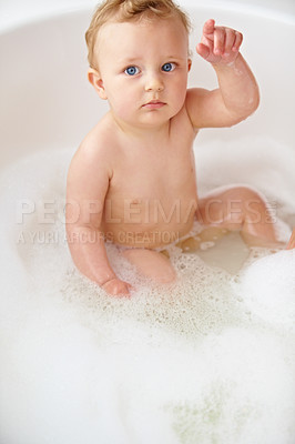 Buy stock photo Baby, face and hand in bubble bath or water cleaning for skin or hair wash for childhood development, hygiene or soap. Child, boy and point in tub for question or confused for cleansing, foam in home