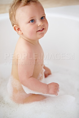 Buy stock photo Cropped shot of a baby boy smiling in the bathtub