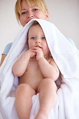 Buy stock photo Baby, towel and portrait with care for mother with comfort or love in a closeup or family home. Mom, hug and holding an infant for bath with cleaning or affection at house for hygiene with happy kid.