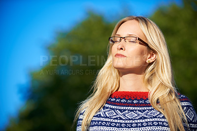 Buy stock photo Shot of an attractive young woman enjoying a day outside