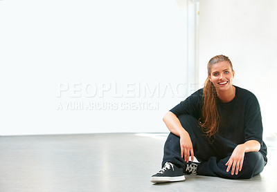 Buy stock photo A beautiful young woman sitting on the floor of her dance studio