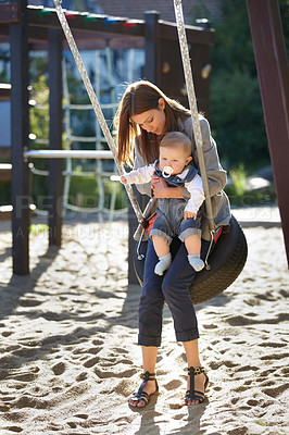 Buy stock photo Mother, baby and swing on park for love, bonding and play with sunshine, child development and care. Woman, kid and infant swinging outdoor in summer for fun, enjoyment and nurture with happiness