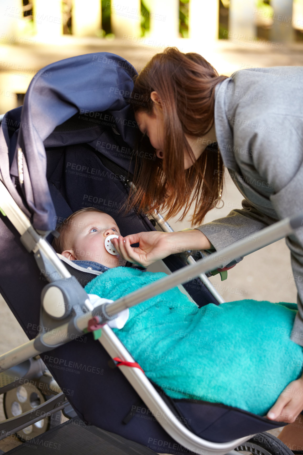 Buy stock photo Mother, baby and pacifier in stroller for walk, together or bonding for exercise, health or wellness. Young woman, infant and giving of dummy for comfort, toddler or child with care in neighborhood