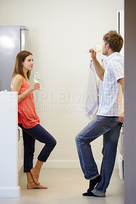 Buy stock photo Love, couple and drinking wine in kitchen for relax, bonding and relationship on weekend in home. People, man and woman with alcohol for peace, date or romance in apartment or house for enjoyment 