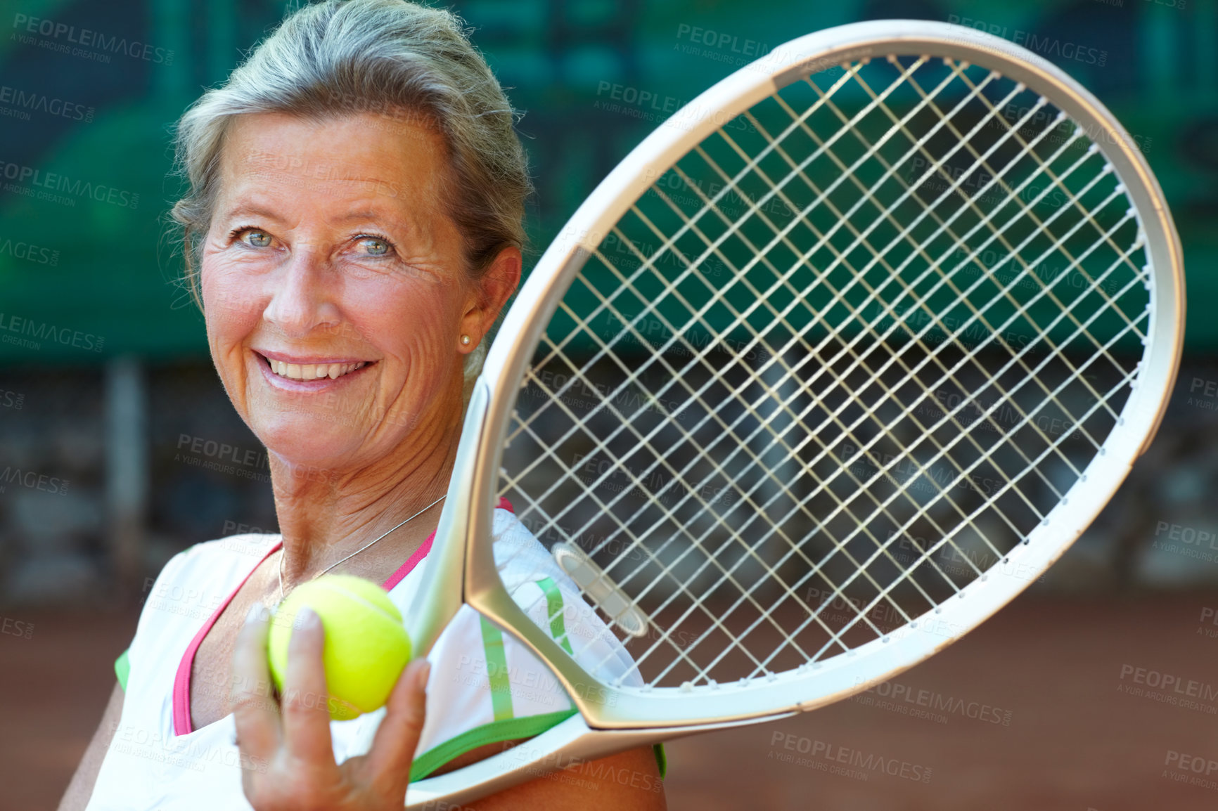 Buy stock photo Senior woman smiling while holding a tennis racquet and ball