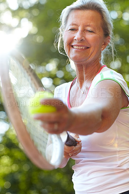 Buy stock photo Smiling senior woman getting ready to serve - Tennis