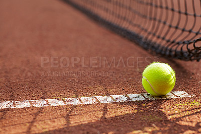 Buy stock photo Tennis, ball and clay court, net and line for exercise, training and fitness outdoor in summer. Sports, netting and closeup of sphere on ground for game, competition and workout on field and pitch