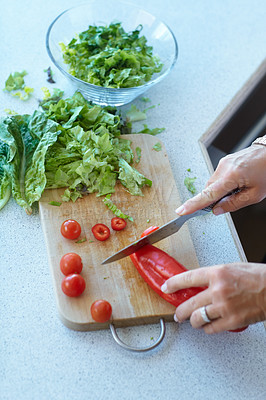 Buy stock photo Hands on chopping board, vegetables and knife on table top in kitchen cooking food. Closeup of cutting plants on counter, above and tomato, pepper and nutrition for healthy lettuce salad in home