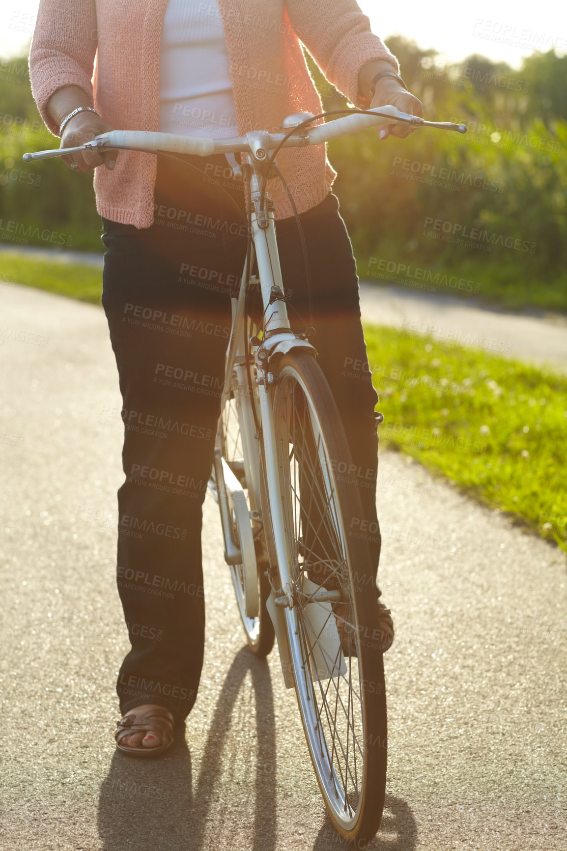 Buy stock photo Nature, fitness and woman on a bicycle for exercise, workout and training on a street in park. Sports, health and closeup of female person cycling on a bike for an outdoor adventure in a garden.