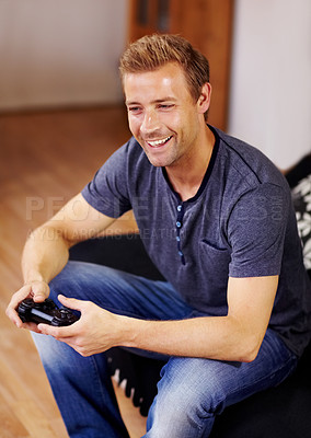 Buy stock photo Man, video game and home on sofa, controller or smile for online competition, relax or press in lounge. Gamer person, playing and idea with click for strategy, streaming or digital challenge on couch