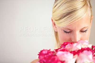 Buy stock photo Smelling, floral and woman with flowers as a gift isolated on a grey studio background. Surprise, romantic and girl with a bouquet of roses for valentines day on a backdrop with mockup space
