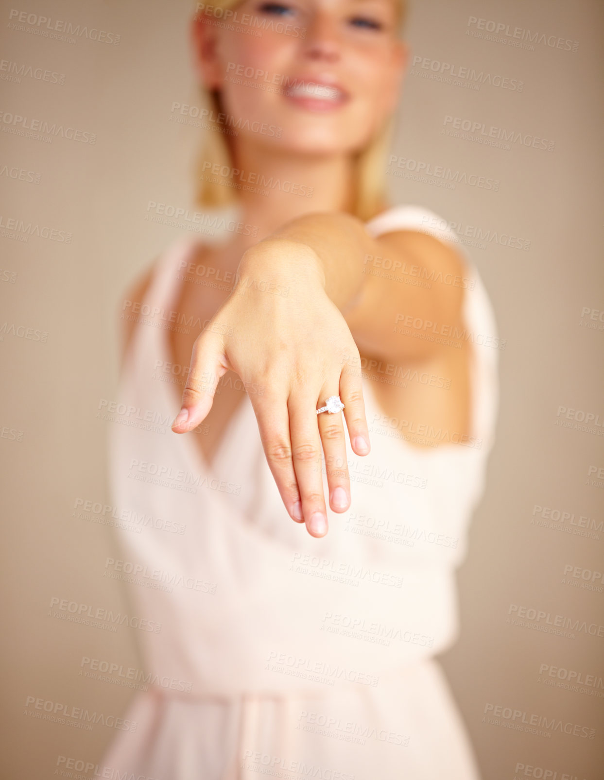 Buy stock photo Cropped shot of a young woman displaying her engagement ring