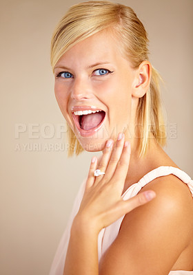 Buy stock photo Woman, excited and engagement ring in studio portrait with smile for proposal, wedding or commitment by background. Girl, model and jewelry for marriage, diamond and metal for celebration at ceremony