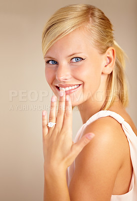 Buy stock photo Woman, happy and wedding ring in studio portrait with smile for proposal, engagement or commitment by background. Girl, model and jewelry for marriage, diamond and metal for celebration at ceremony