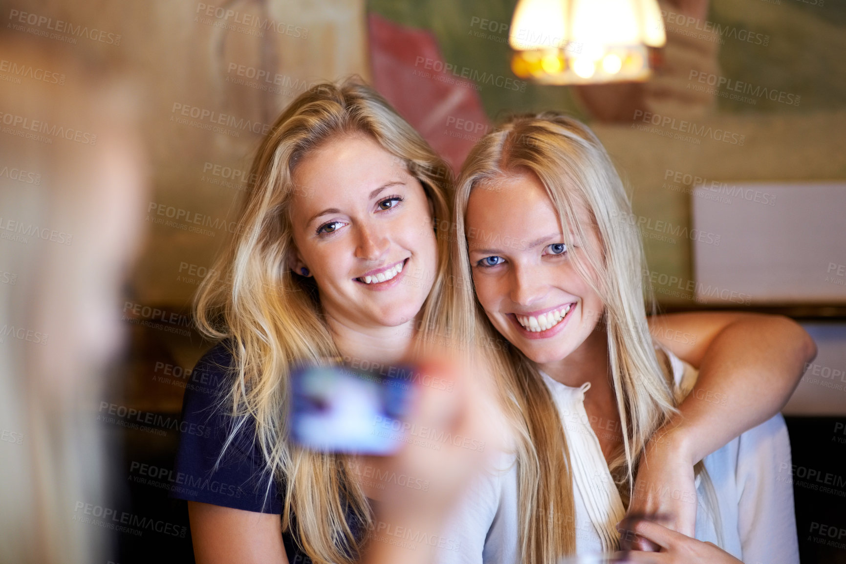 Buy stock photo Friends, women and picture with cafe, smile and smartphone with digital app, pose and memory. People, restaurant and girls embrace, photography or happiness with joy, social media or bonding together