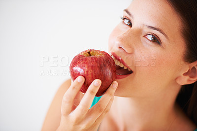 Buy stock photo Health, fruit and portrait of woman with apple eating for nutrition, wellness and snack in studio. Food, balance diet and face of happy person for vitamins, detox and lose weight on white background