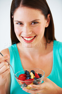 Buy stock photo Woman, portrait and eating a healthy fruit salad with berries, nutrition and health benefits. Face of a happy female person on nutritionist diet with vegan food for weight loss, wellness or detox