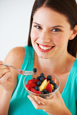 Buy stock photo Health, fruit salad and portrait of woman with berries eating for nutrition, wellness and snack in studio. Food, happy and face of person for vitamins, detox and lose weight on white background