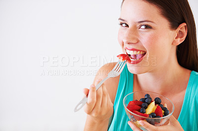 Buy stock photo Portrait of an attractive young woman enjoying a fruit salad