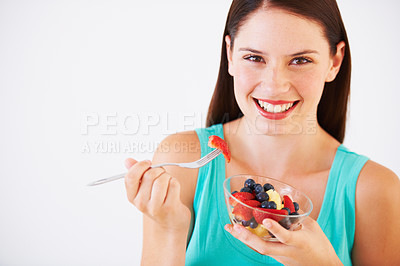 Buy stock photo Food, fruit salad and portrait of woman with smile eating for nutrition, wellness and berry snack in studio. Health, happy and face of person for vitamins, diet and lose weight on white background