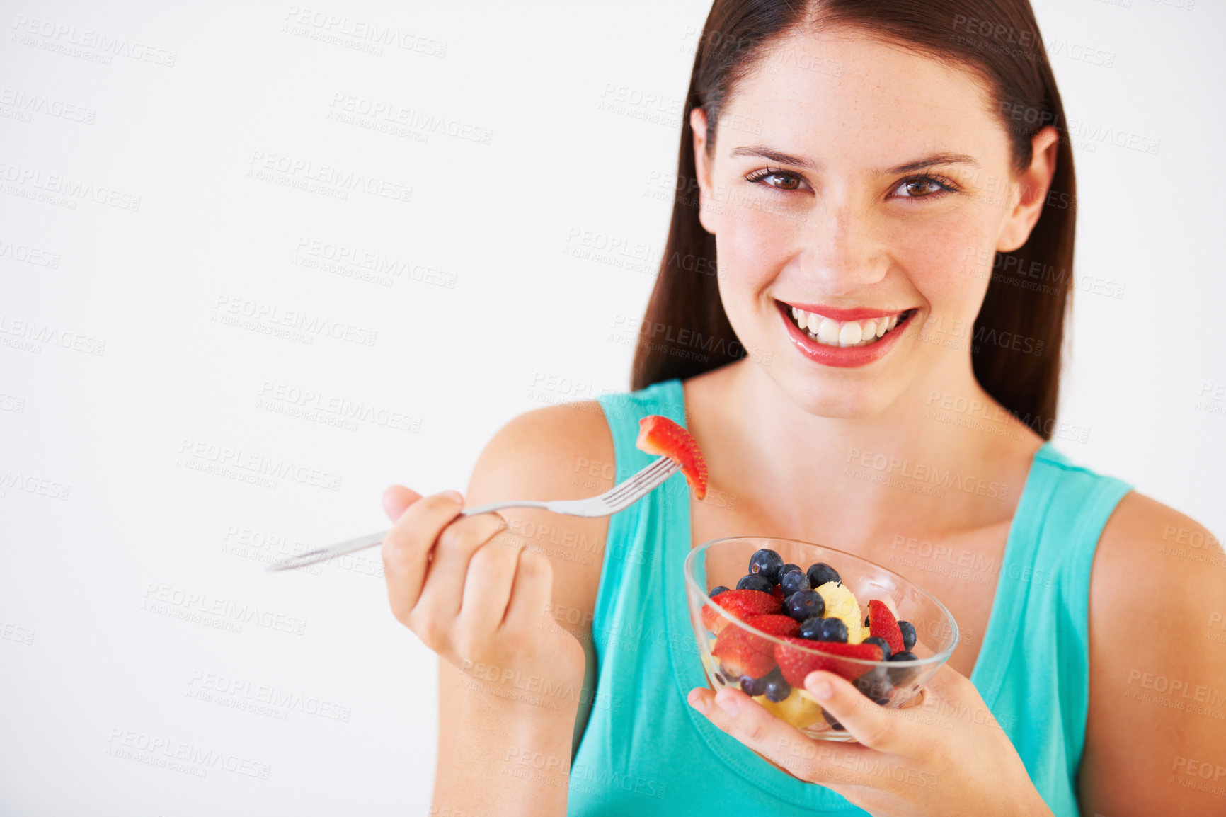 Buy stock photo Food, fruit salad and portrait of woman with smile eating for nutrition, wellness and berry snack in studio. Health, happy and face of person for vitamins, diet and lose weight on white background