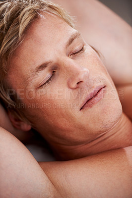Buy stock photo Face, relax and a man sleeping in the bedroom of his home closeup in the morning for peace, rest or a nap. Wellness, dreaming and eyes closed with a young person asleep in an apartment alone