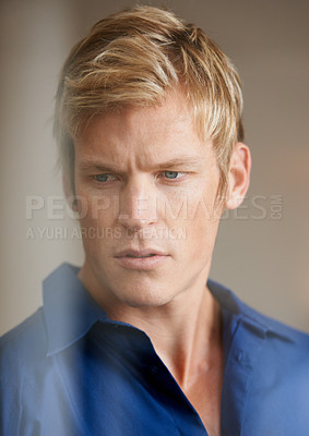Buy stock photo Face, thinking and serious with a man in studio on a brown background behind transparent glass for an event. Idea, doubt and confused with a young person getting ready or dressing in a clothes outfit