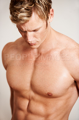 Buy stock photo Fitness, body and muscles with a man in studio on a gray background for health, wellness or power. Gym, natural and a shirtless young model looking strong for exercise, training or a workout